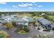 An aerial view of the community clubhouse, golf course, and pond with fountain at 6834 Fairview Ter # 6834, Bradenton, FL 34203