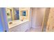 Bathroom with double vanity, large mirror and a shower/tub combo offering a clean and functional design at 6834 Fairview Ter # 6834, Bradenton, FL 34203