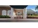 The clubhouse entrance features white pillars, and an outdoor seating area at 6834 Fairview Ter # 6834, Bradenton, FL 34203