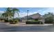 Exterior view of the clubhouse with well-maintained landscaping, clearly marked cart path, and easy access parking at 6834 Fairview Ter # 6834, Bradenton, FL 34203