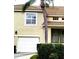 Exterior of property featuring a one-car garage and palm tree in front at 6834 Fairview Ter # 6834, Bradenton, FL 34203