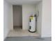 Utility area featuring a water heater and room for storage at 6834 Fairview Ter # 6834, Bradenton, FL 34203