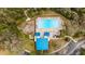 Aerial view of community pool with blue shelters and surrounding trees at 6955 Stetson Street Cir, Sarasota, FL 34243