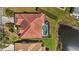 Aerial shot showcasing the tile roof and screened pool area, with a beautiful lake view at 6955 Stetson Street Cir, Sarasota, FL 34243