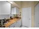 This is a nice bar area with granite countertops, white cabinets, and a sink at 6955 Stetson Street Cir, Sarasota, FL 34243