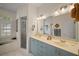 Bathroom with double sinks, a walk-in shower, and a soaking tub at 6955 Stetson Street Cir, Sarasota, FL 34243