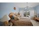 This bedroom features a king bed, ceiling fan, and access to the lanai at 6955 Stetson Street Cir, Sarasota, FL 34243