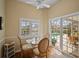 Bright breakfast nook features a glass table and view of the pool and outdoor patio at 6955 Stetson Street Cir, Sarasota, FL 34243