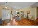Dining room with hardwood floors, a chandelier, and a view of the front door at 6955 Stetson Street Cir, Sarasota, FL 34243