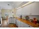 Bright kitchen featuring stone countertops, stainless steel appliances, and wood flooring at 6955 Stetson Street Cir, Sarasota, FL 34243
