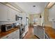 Modern kitchen featuring stainless steel appliances, stone countertops, and white cabinetry at 6955 Stetson Street Cir, Sarasota, FL 34243