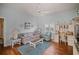 Bright living room with hard wood floors, ceiling fan, and plenty of seating at 6955 Stetson Street Cir, Sarasota, FL 34243