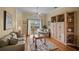 Cozy living room with hardwood floors, a ceiling fan, and sliding glass doors leading to the patio at 6955 Stetson Street Cir, Sarasota, FL 34243