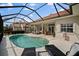 Spacious pool area with a large pool, lounge chairs, and outdoor seating, perfect for entertaining at 6955 Stetson Street Cir, Sarasota, FL 34243