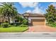 Charming single-story home with a tile roof, manicured landscaping, and a brick driveway at 7112 Marsh View Ter, Bradenton, FL 34212