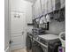 Laundry room featuring a washer and dryer, storage space and a hanging rack at 7112 Marsh View Ter, Bradenton, FL 34212