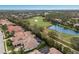 Beautiful aerial view highlighting a terracotta-roofed home close to a scenic golf course and a serene lake at 7210 Desert Ridge Gln, Lakewood Ranch, FL 34202