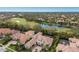 Aerial view of a luxury home and community on a golf course with a pond at 7210 Desert Ridge Gln, Lakewood Ranch, FL 34202