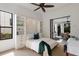 Modern bedroom featuring a bed with built-in storage and sliding doors to an outdoor kitchen and dining area at 7210 Desert Ridge Gln, Lakewood Ranch, FL 34202