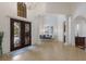 Elegant dining area with a high ceiling, large windows, and stylish chandelier at 7210 Desert Ridge Gln, Lakewood Ranch, FL 34202