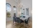 Bright dining room features a modern chandelier, neutral decor, and large windows with natural light at 7210 Desert Ridge Gln, Lakewood Ranch, FL 34202