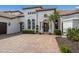 A detailed shot of the front entrance, featuring decorative pillars and manicured bushes at 7210 Desert Ridge Gln, Lakewood Ranch, FL 34202