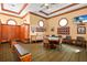 Game room with poker table, comfortable seating, and custom wood cabinetry at 7210 Desert Ridge Gln, Lakewood Ranch, FL 34202