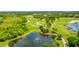 This is an aerial image of a pond with a fountain near a golf course at 7210 Desert Ridge Gln, Lakewood Ranch, FL 34202