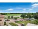 Scenic view of the golf course and practice area with mature trees and well-maintained landscaping at 7210 Desert Ridge Gln, Lakewood Ranch, FL 34202
