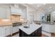 Gourmet kitchen featuring stainless steel appliances and a center island with white countertops at 7210 Desert Ridge Gln, Lakewood Ranch, FL 34202