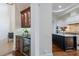 Open kitchen with a wine fridge and a view into a second modern kitchen space at 7210 Desert Ridge Gln, Lakewood Ranch, FL 34202