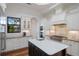 A modern kitchen with a large island, stainless appliances, and a decorative tile backsplash at 7210 Desert Ridge Gln, Lakewood Ranch, FL 34202