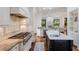 Gourmet kitchen boasts hardwood floors and stainless-steel appliances, ideal for entertaining at 7210 Desert Ridge Gln, Lakewood Ranch, FL 34202