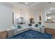Bright living room with a stylish sectional sofa, elegant chandelier, and arched doorways at 7210 Desert Ridge Gln, Lakewood Ranch, FL 34202