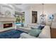 Cozy living room featuring a fireplace, large windows, and a comfortable sectional sofa at 7210 Desert Ridge Gln, Lakewood Ranch, FL 34202