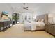 Serene main bedroom features tray ceiling, neutral tones, and a private seating area at 7210 Desert Ridge Gln, Lakewood Ranch, FL 34202