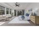 Spacious main bedroom with neutral colors, bright windows, balcony, and an adjoining sitting room for lounging at 7210 Desert Ridge Gln, Lakewood Ranch, FL 34202
