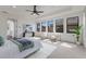 Serene main bedroom featuring neutral tones, ample natural light, and cozy seating with a comfortable lounge at 7210 Desert Ridge Gln, Lakewood Ranch, FL 34202
