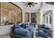 Covered outdoor living area with stylish blue furniture, ceiling fan, and views of backyard at 7210 Desert Ridge Gln, Lakewood Ranch, FL 34202