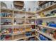 Organized pantry with an assortment of food items on wooden shelves at 7210 Desert Ridge Gln, Lakewood Ranch, FL 34202