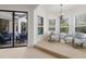 Bright seating area features ample natural light and views of the outdoor pool at 7210 Desert Ridge Gln, Lakewood Ranch, FL 34202