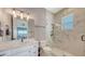 Modern bathroom with marble tile, glass shower, and sleek fixtures at 7706 Desoto Memorial Hwy, Bradenton, FL 34209