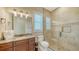 Bathroom with a glass shower, a dark wood vanity with a granite countertop, and modern fixtures at 7706 Desoto Memorial Hwy, Bradenton, FL 34209