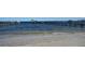 This picture showcases a sandy beach leading up to two private docks and boat lifts, with scenic views at 7706 Desoto Memorial Hwy, Bradenton, FL 34209