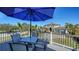Enjoy outdoor dining on this deck featuring a table and chairs under an umbrella at 7706 Desoto Memorial Hwy, Bradenton, FL 34209