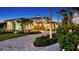 Stunning two-story home with meticulous landscaping, a brick driveway, and beautiful architectural details at 7706 Desoto Memorial Hwy, Bradenton, FL 34209