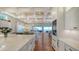 Open-concept kitchen with access to outdoor space and waterfront view, featuring a wine fridge at 7706 Desoto Memorial Hwy, Bradenton, FL 34209
