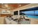 Open floor plan with ample seating overlooks the pool and bay at 7706 Desoto Memorial Hwy, Bradenton, FL 34209