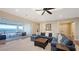 Living room with a spacious sectional sofa, hardwood floors, and sliding glass doors with water views at 7706 Desoto Memorial Hwy, Bradenton, FL 34209