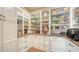 Well-stocked pantry with custom white shelving, cabinets, and wood countertops provides ample storage space at 7706 Desoto Memorial Hwy, Bradenton, FL 34209